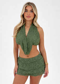 woman in a khaki lace outfit on a white background