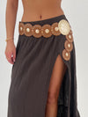 Brown skirt with decorative belt on a plain background