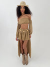 Woman wearing a camel outfit with a hat on a white background