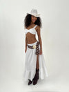 Woman wearing a white outfit , burgundy belt, and cowboy hat on a white background